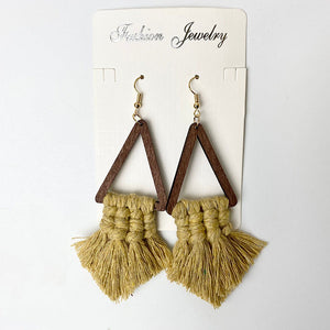 Macrame triangle tassel earrings with wooden frames in a natural tan color.