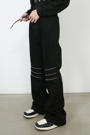 Black bootcut jeans with zipped knee detail