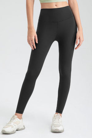 Black high-waist performance leggings with sculpted seams and a full-length cut.