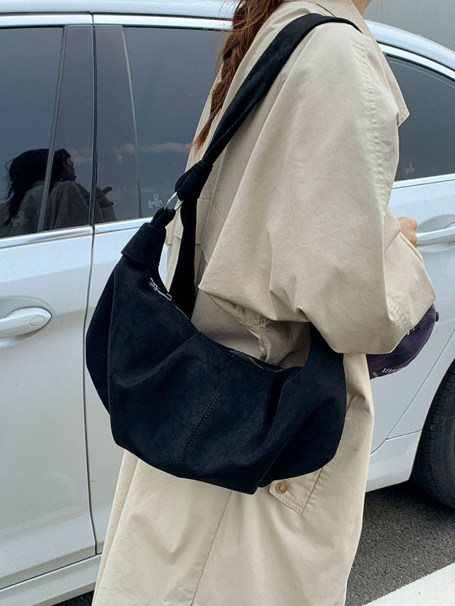 crossbody bag in black featuring knotted strap and relaxed fit