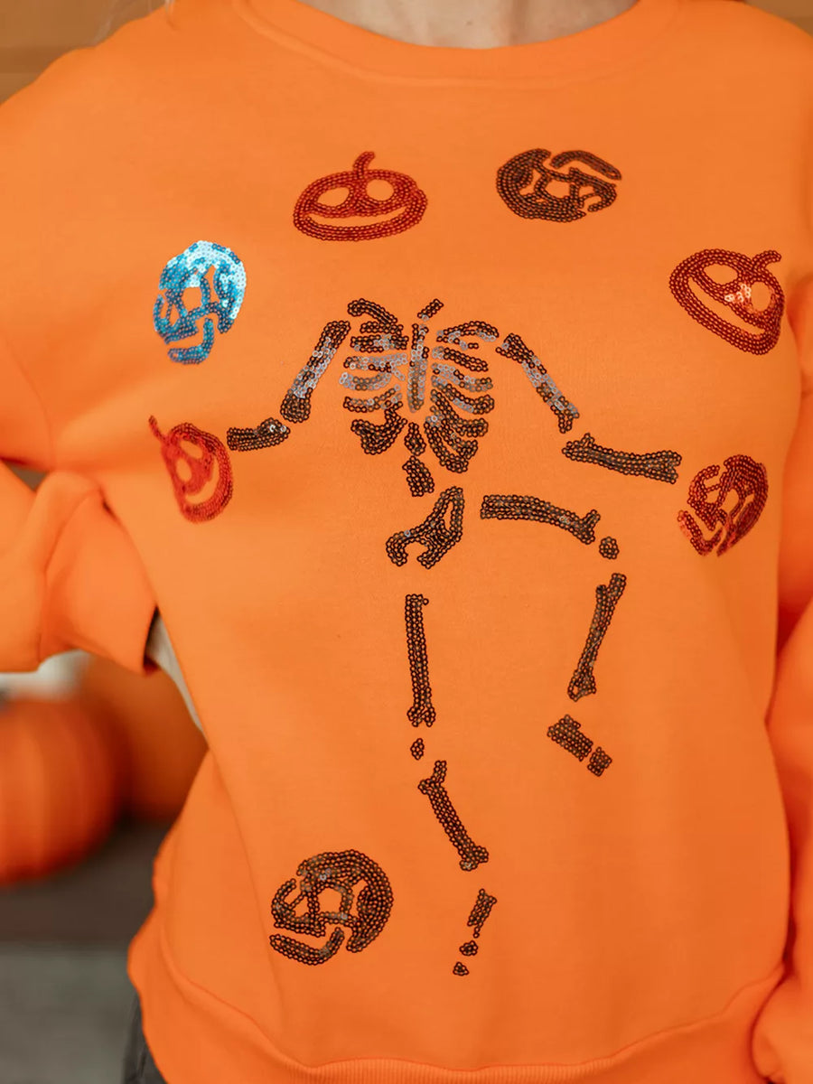 orange crewneck sweater with ribbed cuffs and long sleeve
