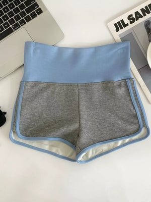 Light blue and gray athletic shorts with contrast trim and high-rise waist.