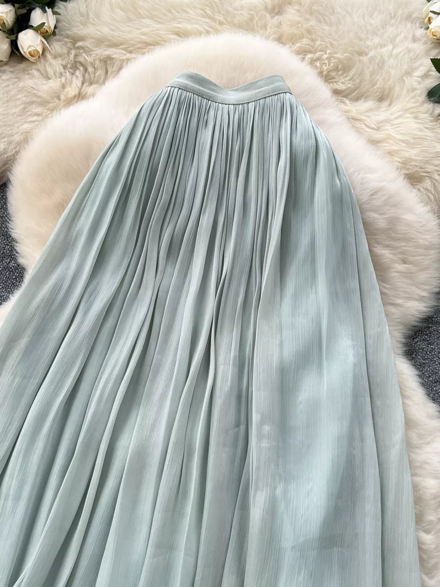 Light green pleated maxi skirt with a flowing A-line cut.