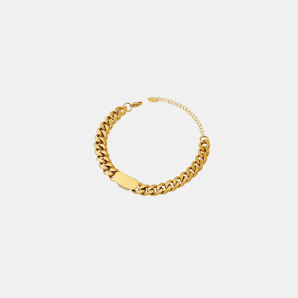 Gold chunky curb chain ID bracelet with a smooth rectangular plate detail.
