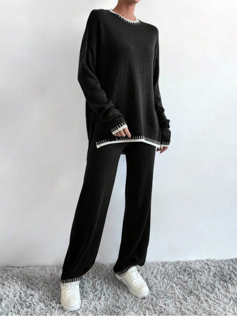 Black acrylic knit loungewear set with white contrast stitching on neckline, cuffs, and hem.