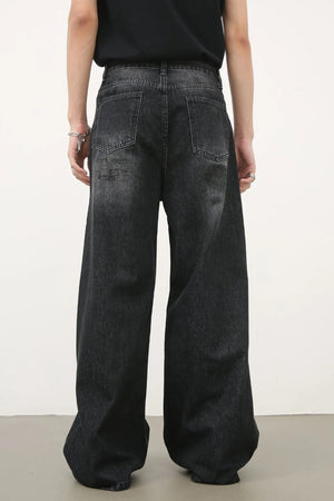 Oversized charcoal wash denim jeans with a wide leg and relaxed fit.