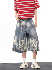Men's wide-leg denim shorts with abstract bleach design and pockets.