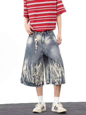 Men's wide-leg denim shorts with abstract bleach design and pockets.