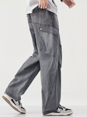 Loose fit cargo pants in grey with drawstring and button flap pockets.