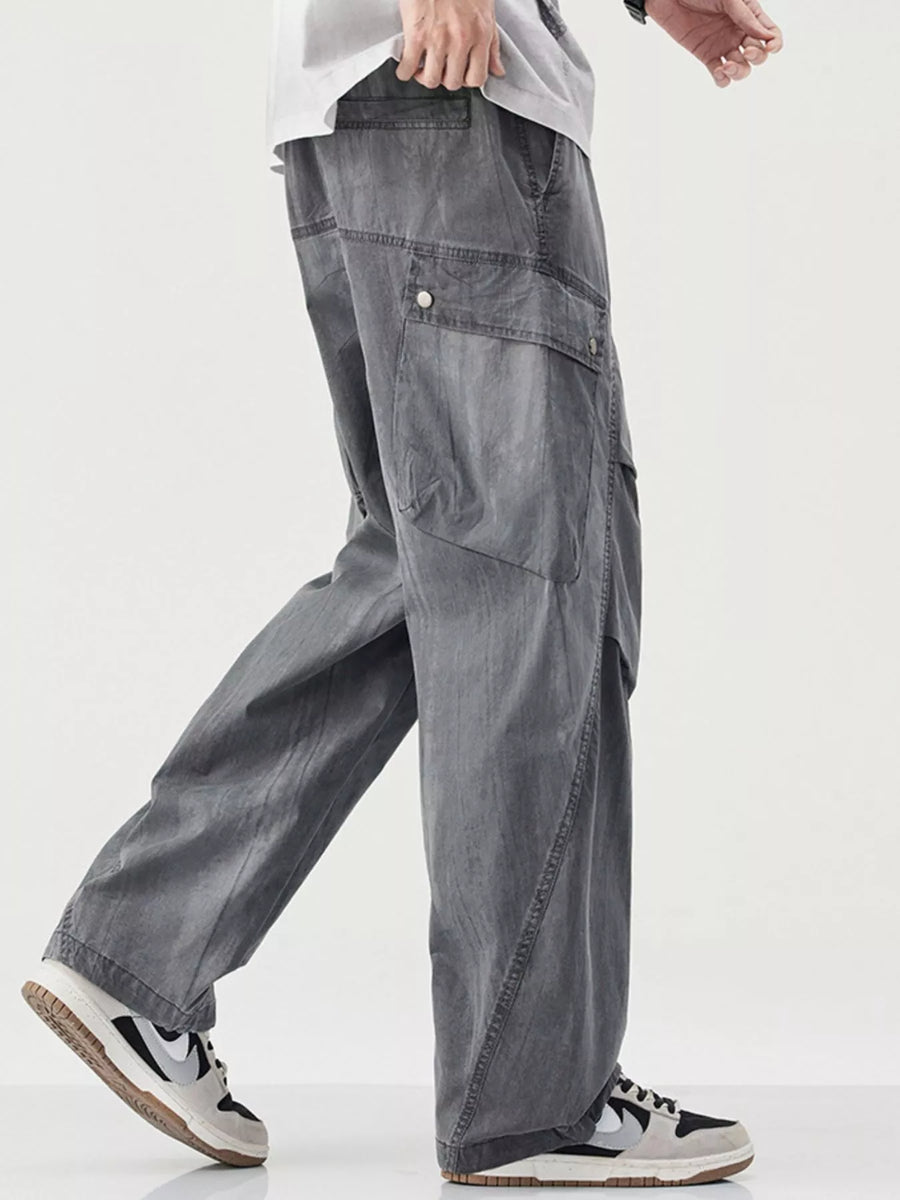 Loose fit cargo pants in grey with drawstring and button flap pockets.