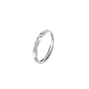 Adjustable sterling silver ring with cubic zirconia in a twisted design.