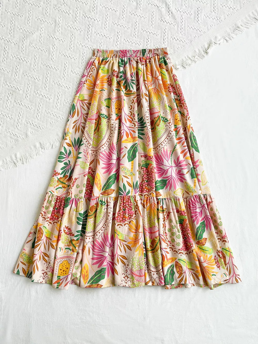 Tropical ruched maxi skirt with ruffles and a vibrant floral print.