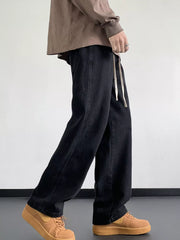 Black oversized drawstring jeans with a loose fit and a visible drawstring waist.