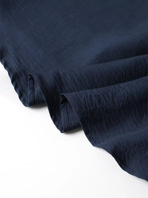 Navy blue crinkled fabric with a subtle texture.