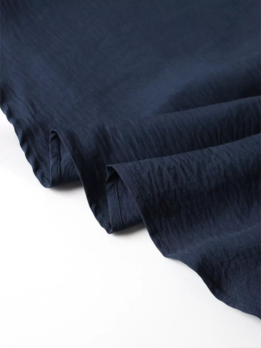 Navy blue crinkled fabric with a subtle texture.