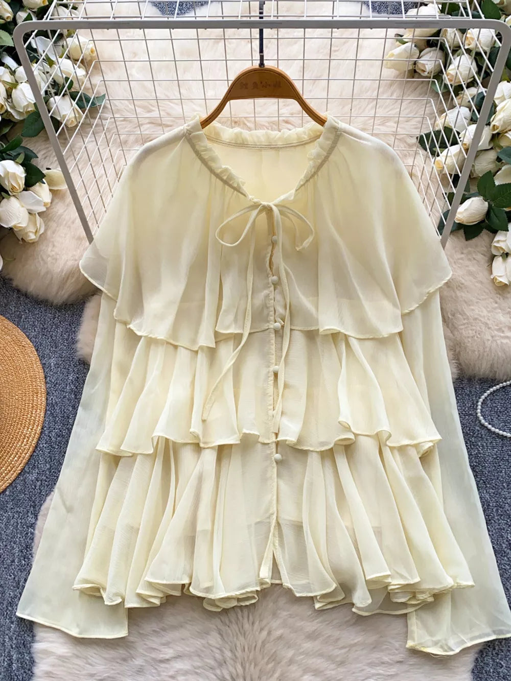 Yellow chiffon tiered blouse with ruffled details and bow tie neckline