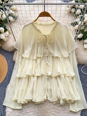Yellow chiffon tiered blouse with ruffled details and bow tie neckline