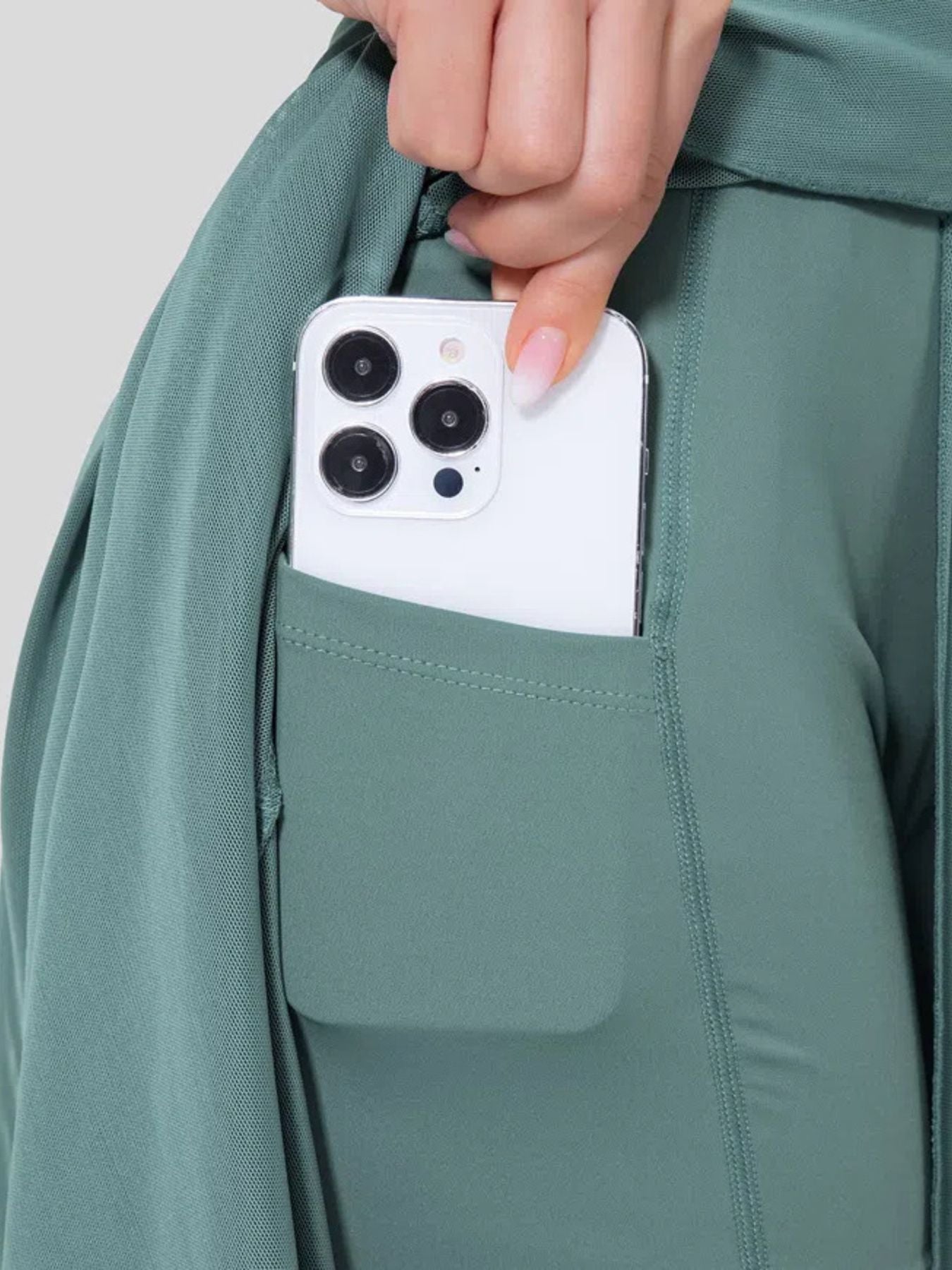 Flowy midi skirt in Lake Blue with built-in shorts liner and pocket holding a smartphone.