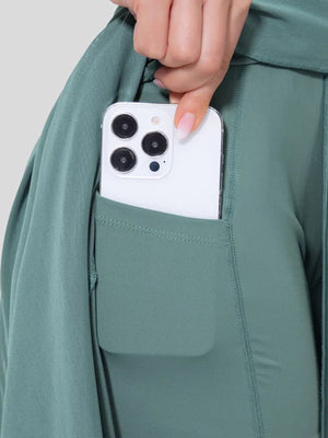 Flowy midi skirt in Lake Blue with built-in shorts liner and pocket holding a smartphone.