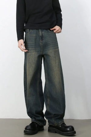 Faded baggy denim jeans in a distressed light blue wash with a relaxed fit.
