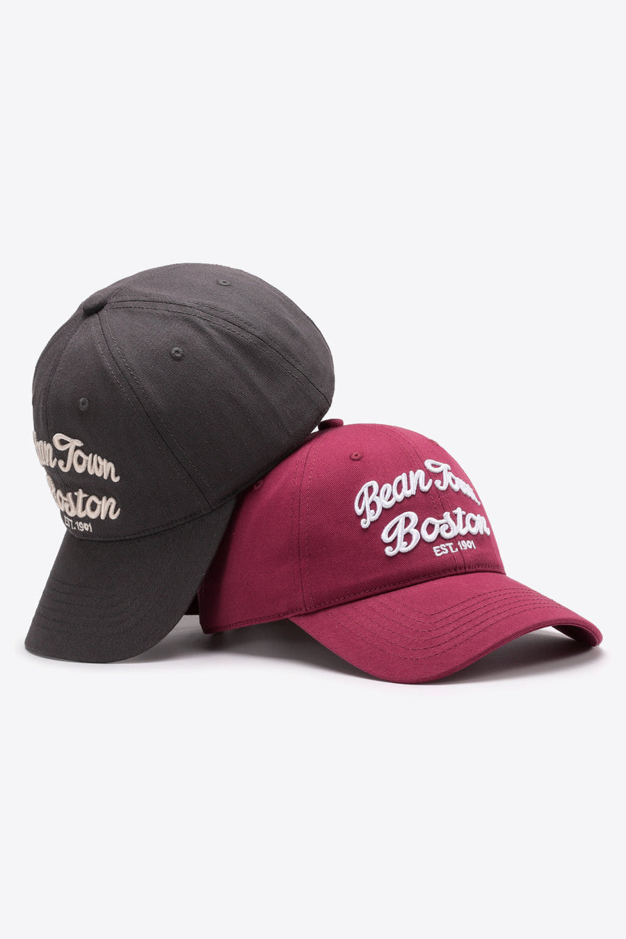 Boston baseball caps in Deep Red and Dark Gray with white script embroidery.