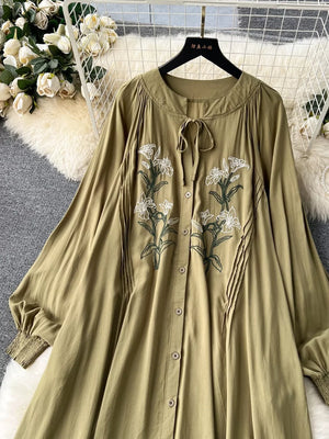 Khaki cotton maxi dress with embroidered floral detail and tie neck.