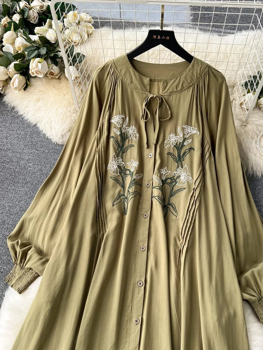 Khaki cotton maxi dress with embroidered floral detail and tie neck.