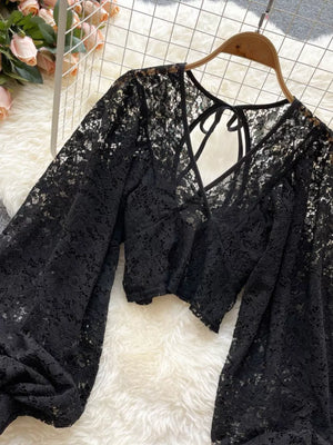 Black floral lace tie-back shirt with balloon sleeves and a cropped cut.