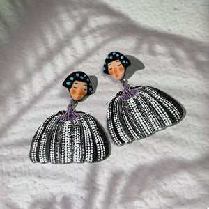 Whimsical pumpkin girl dangle earrings in black with white polka dot skirts and blue spotted hair.
