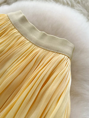 Yellow pleated maxi skirt with a satin waistband detail