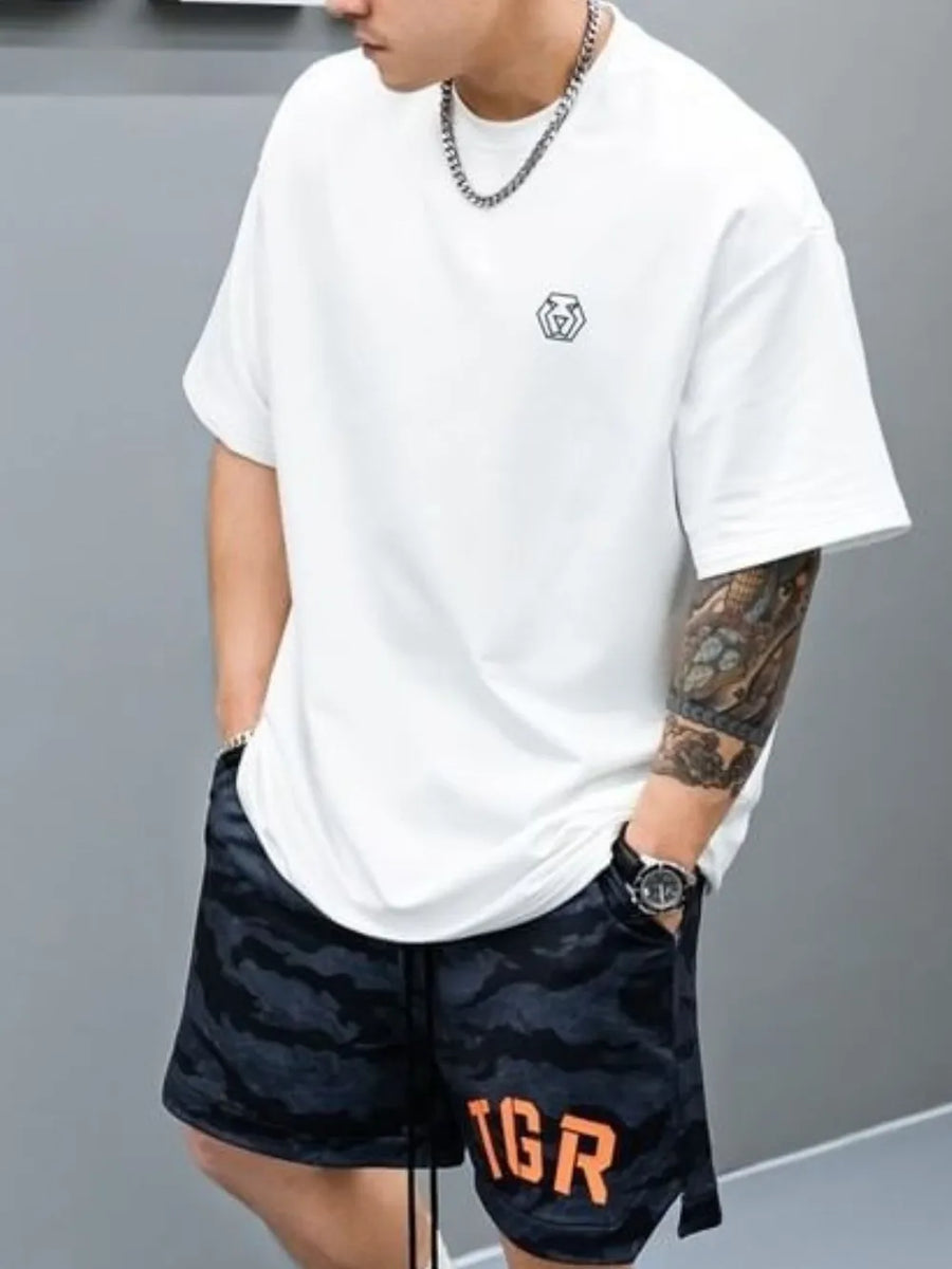 White oversized t-shirt with minimalist emblem detail on chest.