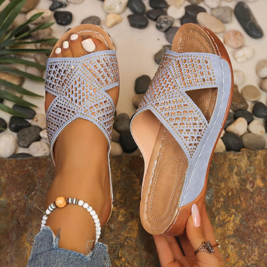 Sky blue criss-cross wedge sandals with rhinestone embellishments and open toe.