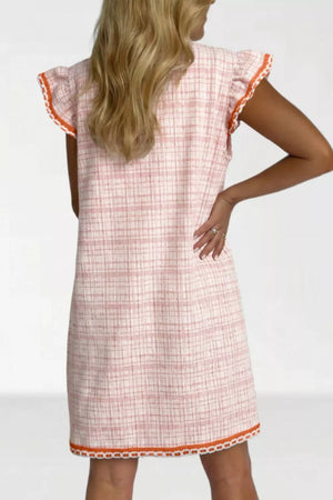 Pink jacquard shift dress with ruffled trim and orange trim detail.