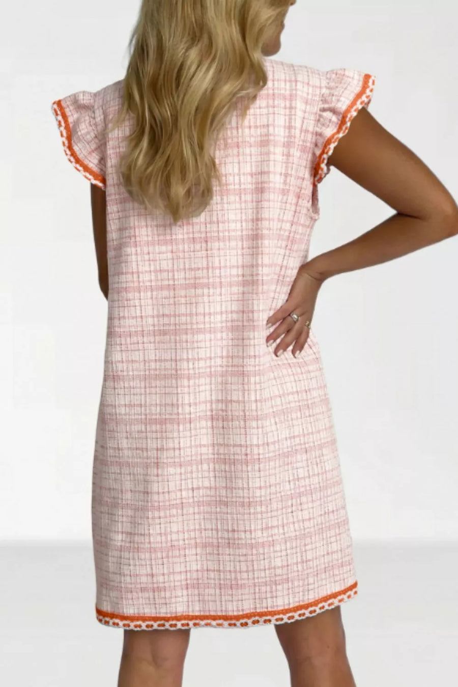 Pink jacquard shift dress with ruffled trim and orange trim detail.
