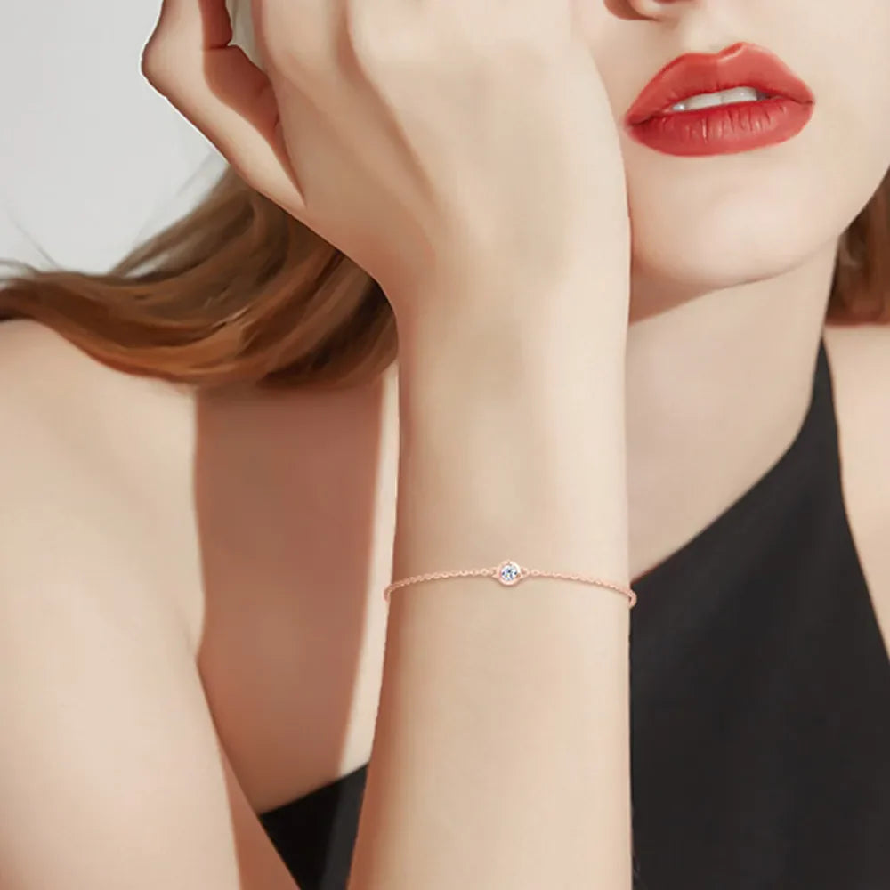 Rose gold moissanite solitaire chain bracelet with a single sparkling stone.