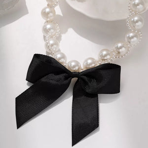 Pearl choker necklace with black ribbon bow detail