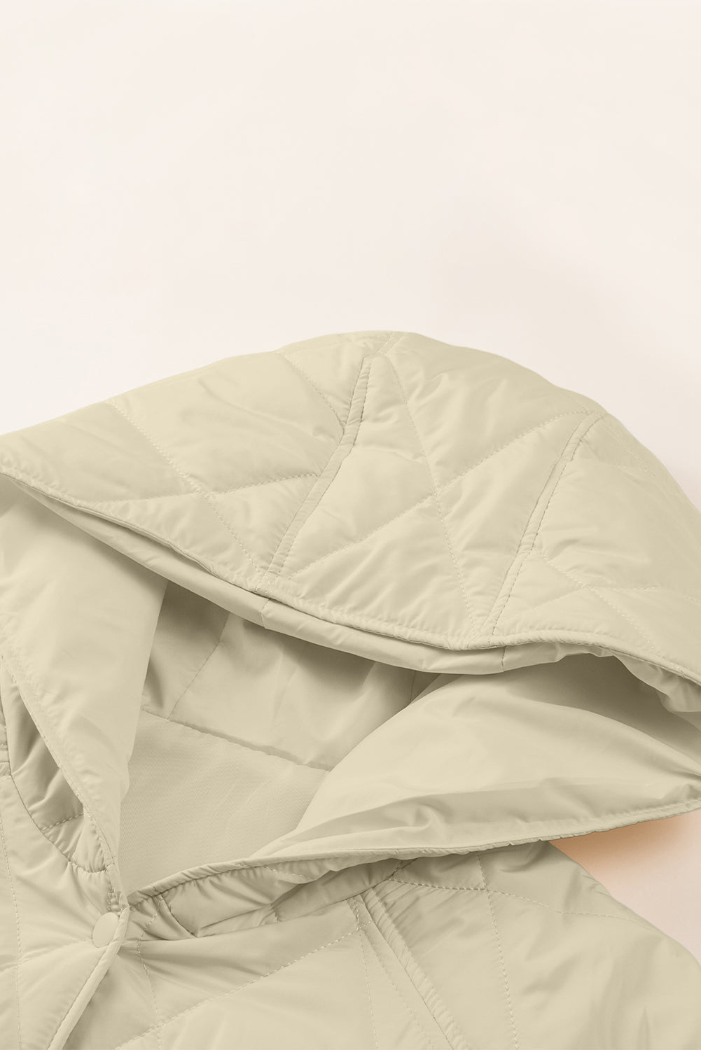 Beige diamond quilted hooded snap jacket detail with snap closure