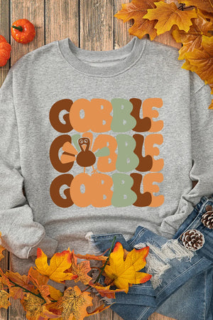 Gray crewneck sweatshirt with a Gobble graphic featuring a turkey and autumn colors.