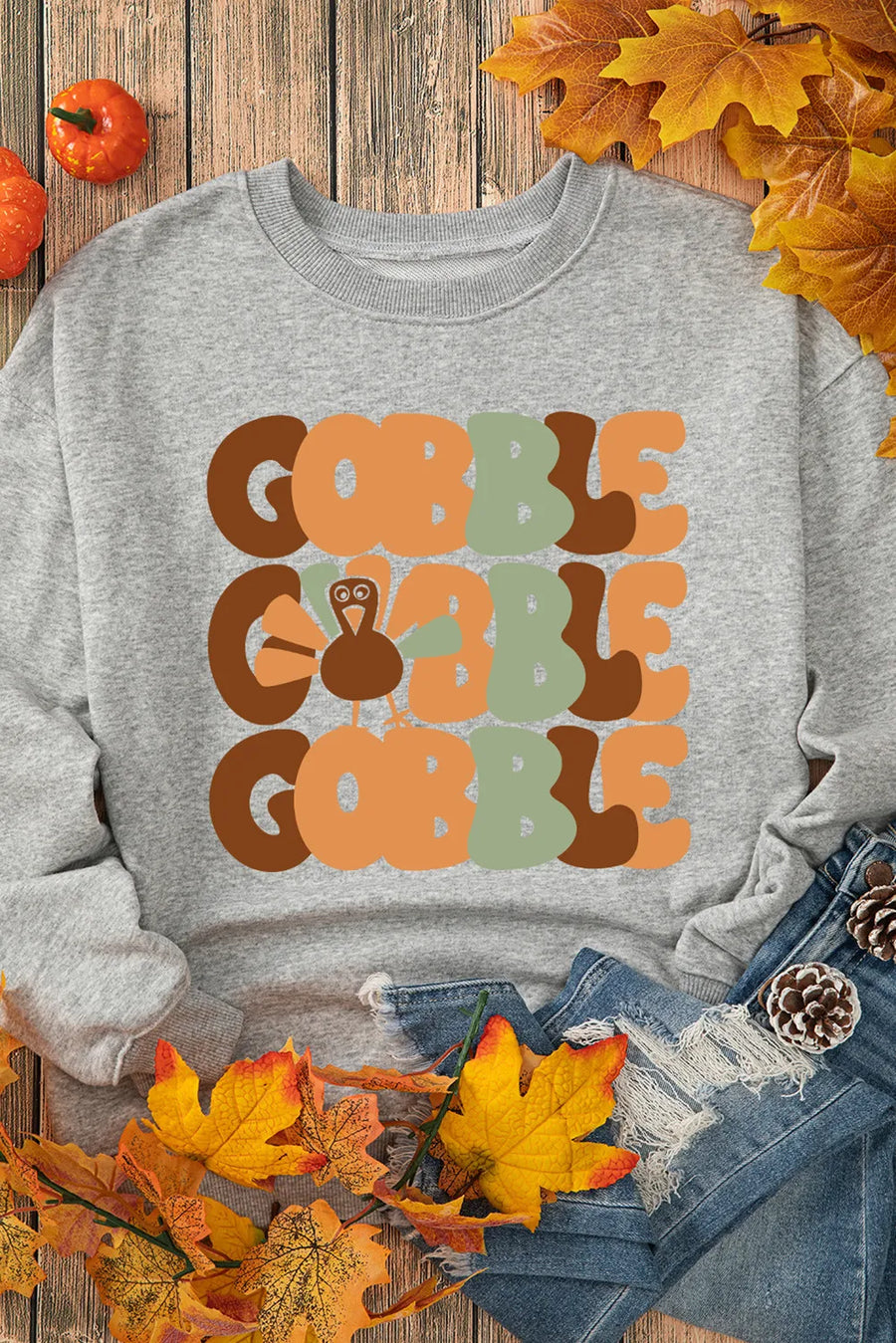 Gray crewneck sweatshirt with a Gobble graphic featuring a turkey and autumn colors.