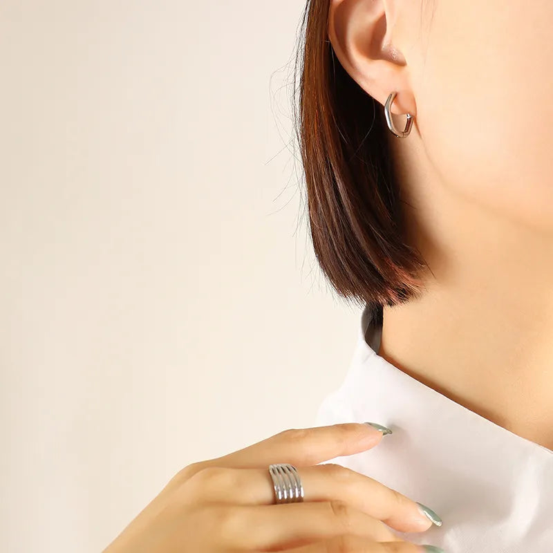 Silver sharp triangle huggie earrings and stacked band ring made of steel.