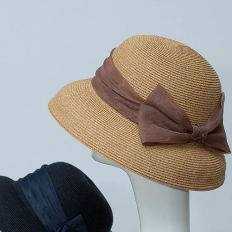 Straw sun hat in Khaki with a large brown organza bow detail.