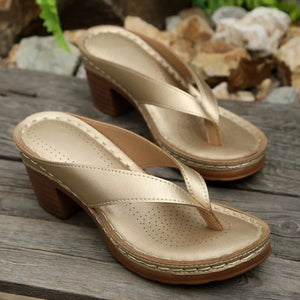 Gold toe-post block heel sandals with perforated insoles and contrast stitching.