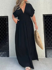 Black V-neck maxi dress with smocked waist and dolman sleeves.