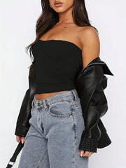 Black gathered bustier bandeau top with ruched detail, styled with jeans and a leather jacket.