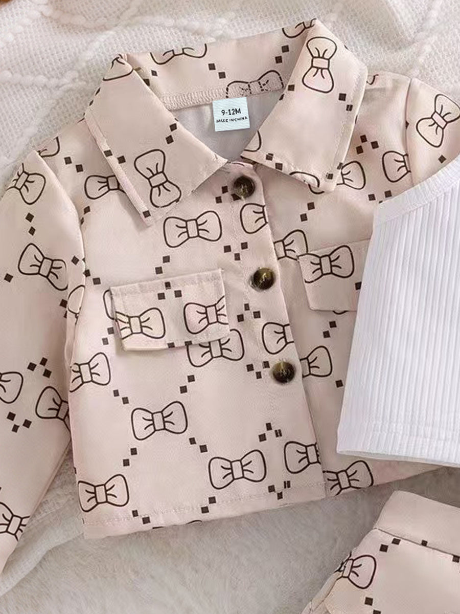 white outfit set featuring buttoned and bow-print