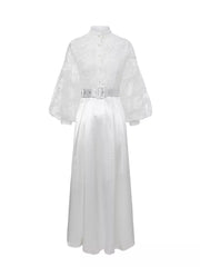 White lace-embellished maxi dress with lantern sleeves, high neck, button front, and white belt.