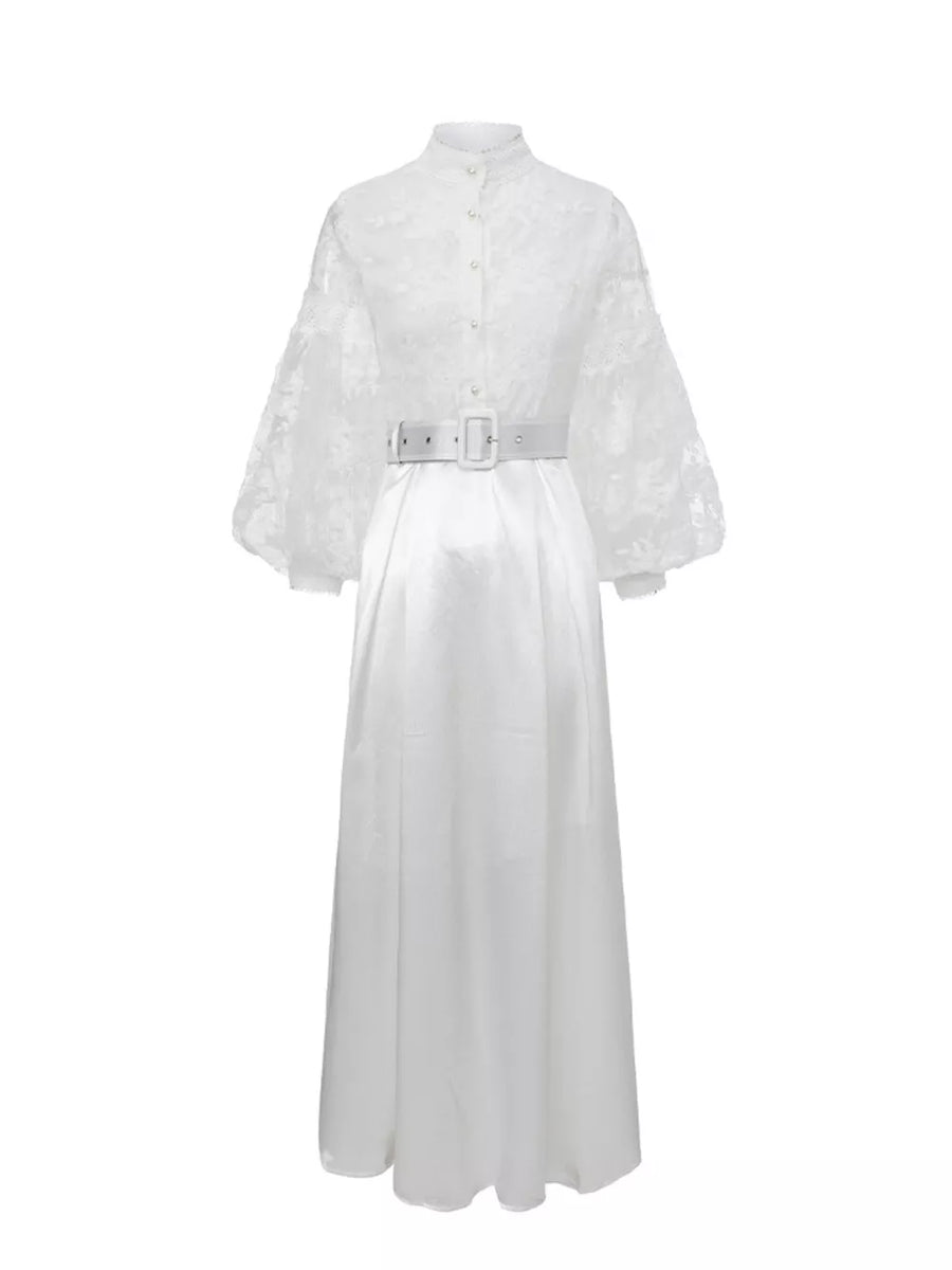 White lace-embellished maxi dress with lantern sleeves, high neck, button front, and white belt.