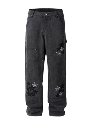 Dark wash carpenter jeans with embroidered stars and checkered pattern details.