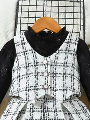 Toddler black and white plaid vest set with decorative buttons over a black lace top.