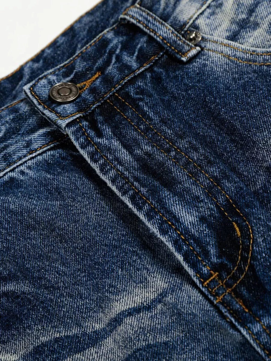 Men's light blue vintage wash wide leg jeans detail showing button and stitching